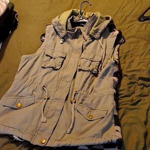 Green bomber vest with Aztec design on back.